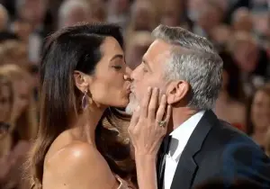 George Clooney couldn't tear himself away from his wife, who came to the star-studded party in a seductive outfit