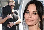 Reunited with her fiancé, Courteney Cox can't tear herself away from him