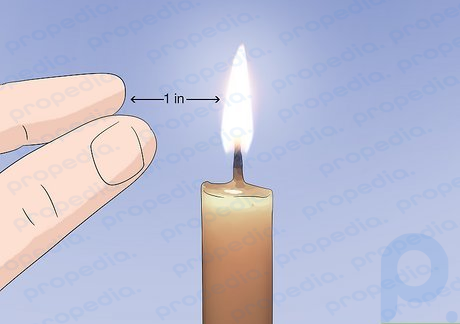 Step 3 Place your hand about 1 inch (2.5 cm) away from the flame/wick.