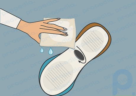 Step 1 Clean the area around the hole in your shoe with a wet rag.