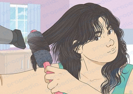 Step 3 Go back with a round brush and blow-dry your hair to curl the ends.