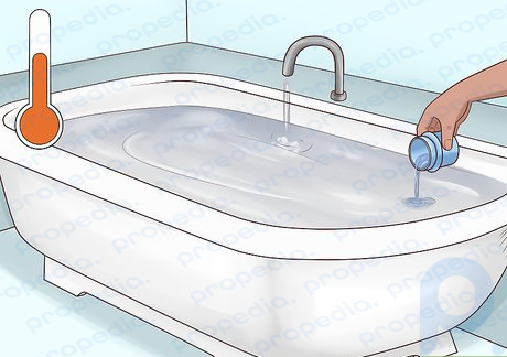Step 1 Fill your bathtub with lukewarm water and add your detergent.