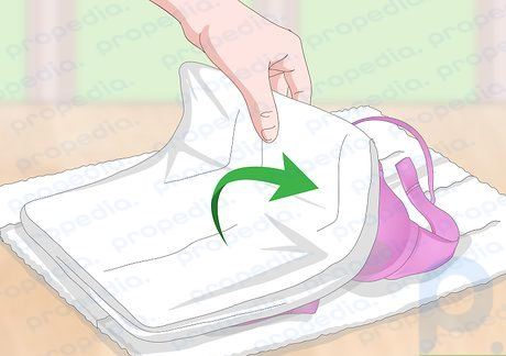 Step 1 Roll the bras between two thick towels to press out excess water.