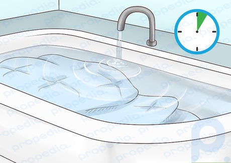 Step 4 Soak and massage your comforter in fresh water to rinse out the soap.