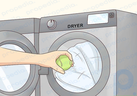 Step 6 Place the comforter in the dryer and add 1 to 3 tennis balls.