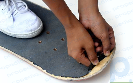 Step 4 Stand on the board for leverage, once the edge of grip tape is pulled up.