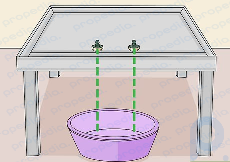 Step 5 Place the flood table on a stand with a bucket.