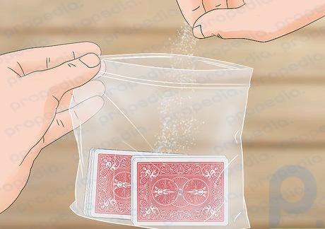 Step 4 Sprinkle talcum powder or flour on your cards when they get dirty.