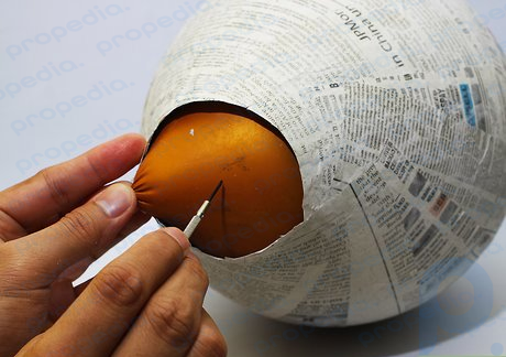 Step 4 When the papier mache has dried pop the plastic balloon and remove its remnants.