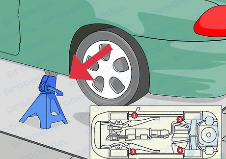 Paso 4 Nuevamente consultando el manual del propietario, coloque soportes de gato a ambos lados del vehículo.