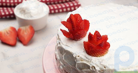 Étape 7 Utilisez une noisette de crème au beurre pour coller la rose sur votre gâteau.