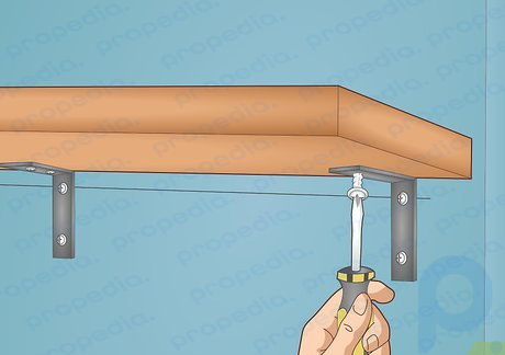 Step 4 Attach your shelf to the brackets with your remaining screws.