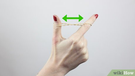 Step 1 Hold the rubber band between your index and thumb fingers.